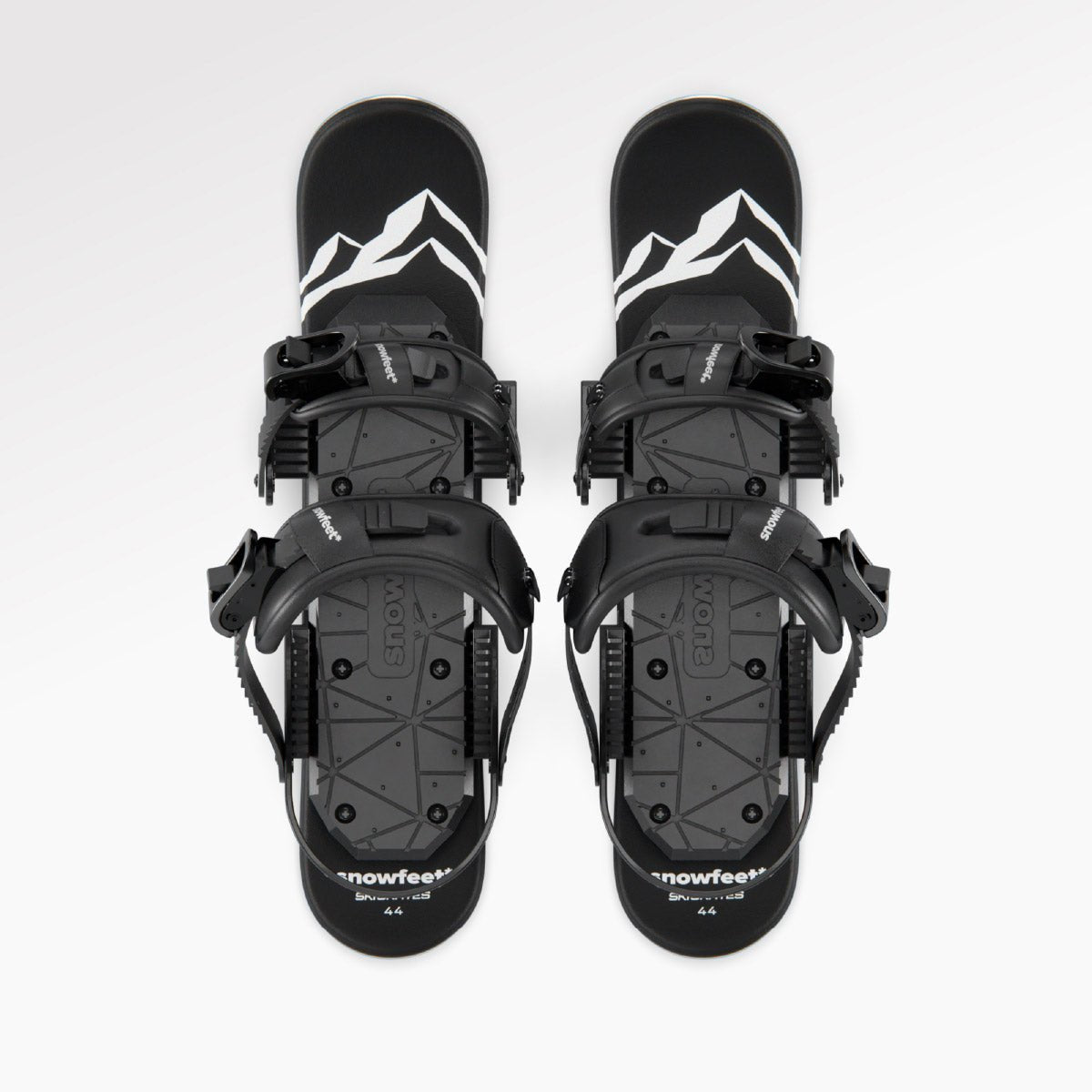 Pair of black snowboard bindings with white mountain design on a white background. Black snowboard bindings on a white background. Mini skis, snowfeet.