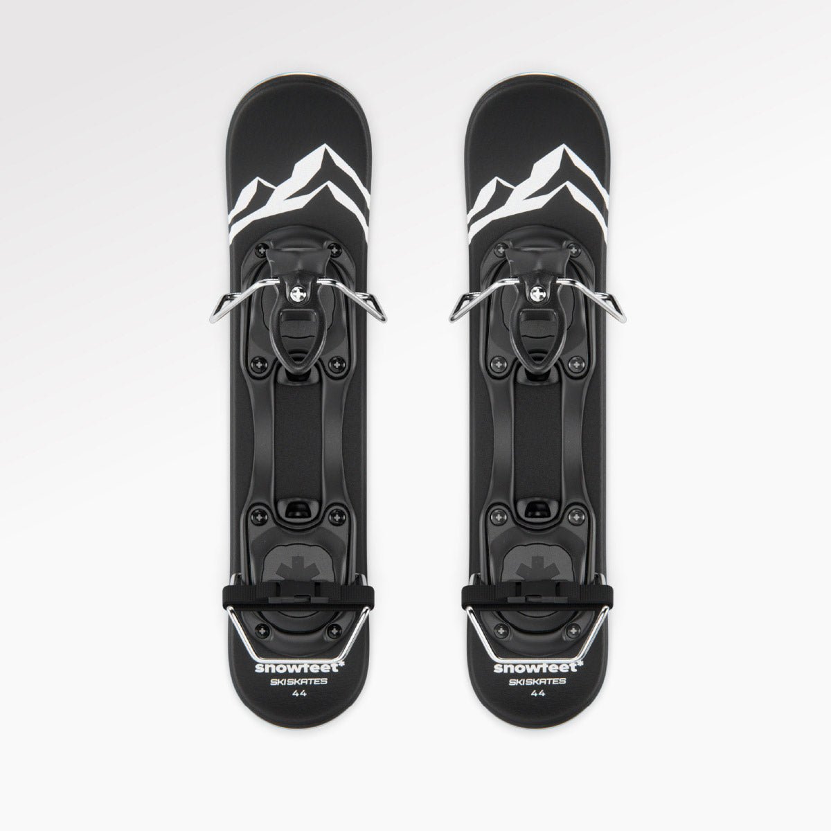 Two black short skis with white accents on a white background