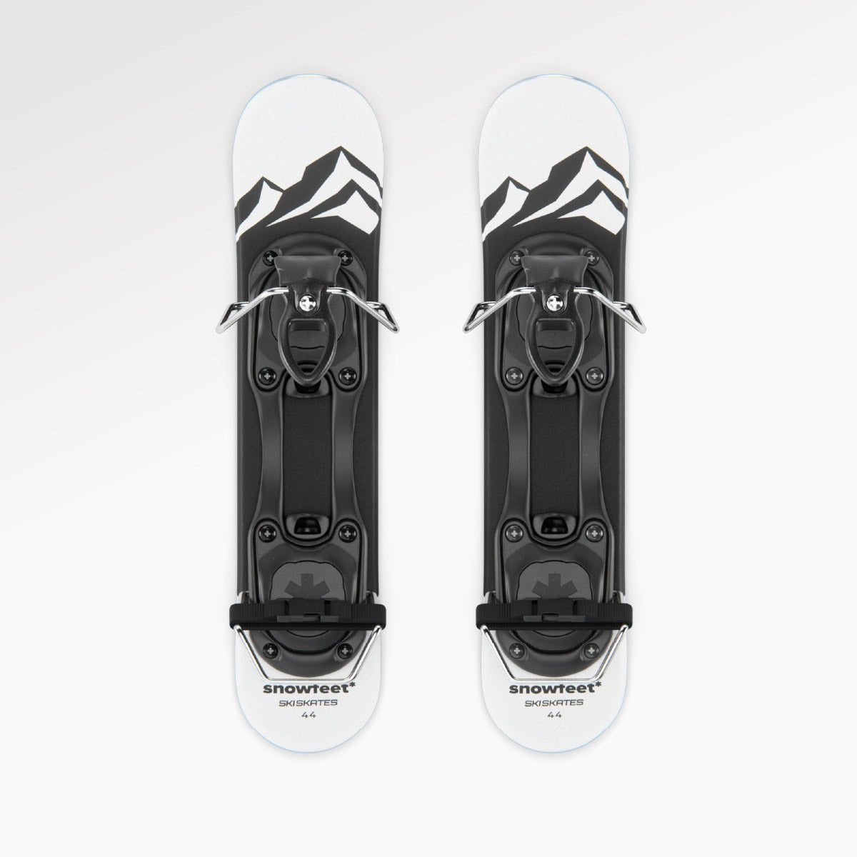 Two short skis with bindings on a white background